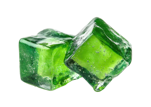 Two vibrant green, translucent ice cubes on black