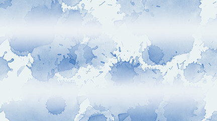 Abstract blue watercolor ink splashes and splatters on white background with a soft gradient fade effect