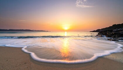 Coastal Serenity Gentle Wave Rolls Onto Sandy Beach During Golden Hour Sunset Sky Reflection In Water And Calm Ocean Horizon