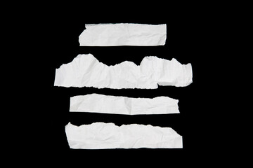 White paper cut with torn edges isolated on black background.