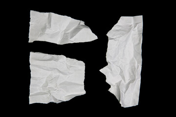 White paper cut with torn edges isolated on black background.