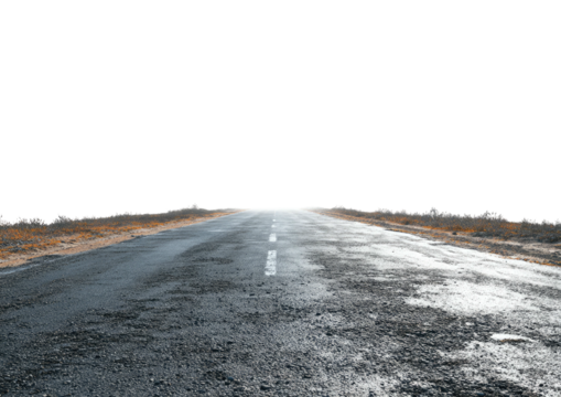 Paved road stretches into the distance under black sky