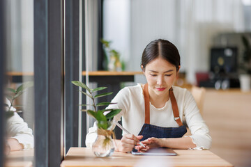 Startup successful small business owner sme beauty girl work in coffee shop restaurant. Portrait of asian tan woman barista cafe owner SME
