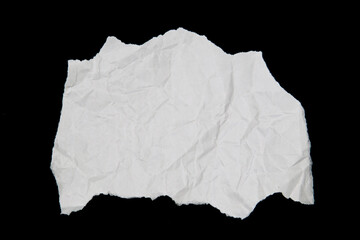 White paper cut with torn edges isolated on black background.