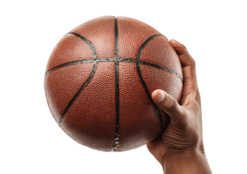 Hand firmly grips round, textured basketball, warm lighting