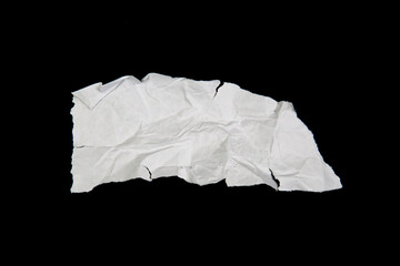 White paper cut with torn edges isolated on black background.