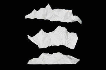 White paper cut with torn edges isolated on black background.