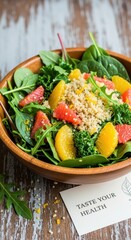 Healthy salad bowl with fresh citrus and greens