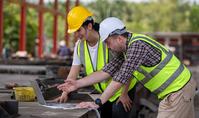 Engineers wearing helmets and vests at construction sit analyzing building plans work environment...
