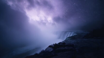 Naklejka premium Misty waterfall at night under a starry purple sky with dramatic clouds