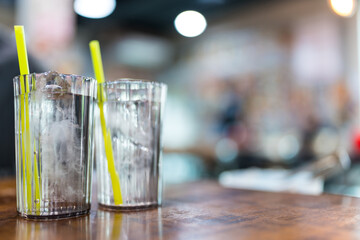 Two glasses of cool water with ice on wood table