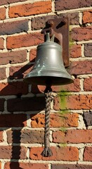 Fototapeta premium Old Brass Bell with Rope Pull on a Brick Wall.