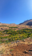 Autumn mountain valley with dry soil, golden foliage, and rugged peaks under clear blue sky — a vivid seasonal contrast.  
📍Hazarani, Hawraman