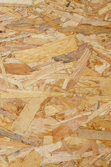 OSB wood chips pressed sheet structure, abstract empty vertical backdrop, close up