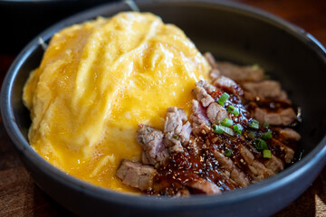 Cheese Omelet served on plate with sliced meat steak, with Thai spicy dipping sauce
