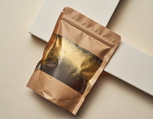 Top view of a blank, resealable kraft paper pouch for organic products, featuring a luxurious gold foil texture on a cream background with geometric elements.