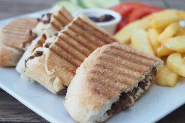 Delicious sandwiches served with fries and fresh vegetables