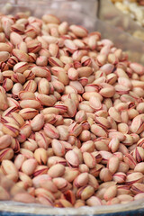 Pistachio nuts displayed at a market stall in a city