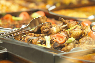 Delicious grilled chicken served at a buffet in a restaurant