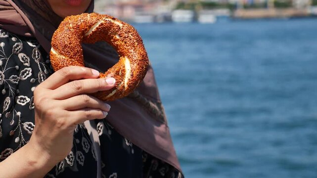 Enjoying a delicious simit by the water