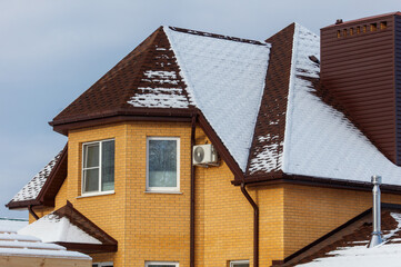 A house with a brown roof and a window