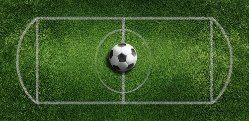 Soccer ball on green grass football field viewed from above with white lines and central circle in sunlight
