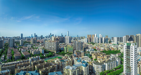 Obraz premium High angle view of a densely populated urban residential district with numerous apartment buildings under a clear blue sky.