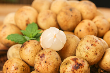 Fresh Longan Dragon Eye Fruits from Thailand - Tropical Asian Exotic Fruit Display with Mint Leaves