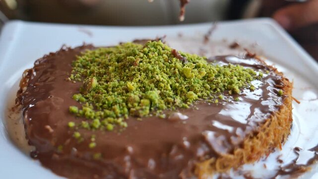 kunafe desert topped with pistachios and chocolate 