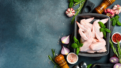 Fresh meat. Set of raw chicken wings. Meat on a plastic black container from the market. Close-up.