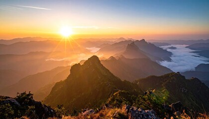 Majestic Mountain Range Bathed in Golden Sunrise Light with Wispy Clouds Below