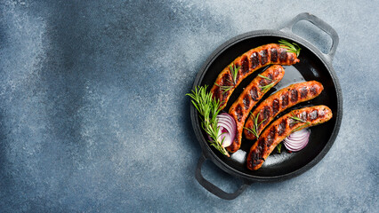 Pan with baked beef sausages. Homemade food. Barbecue or grill menu.