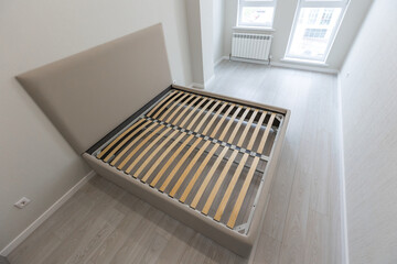 Comfortable gray bed with wooden slats шт empty modern grey bedroom