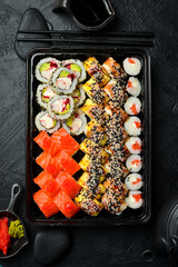 Set of sushi rolls and maki with fish, caviar, cheese and avocado. Close-up.