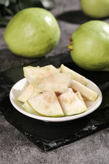 Fresh Guava Fruit Slices with Creamy White Flesh on Plate - Tropical Asian Fruit from Guangxi