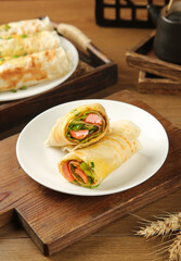 Ham and Egg Breakfast Pancake Wraps with Vegetables on Rustic Wooden Serving Boards