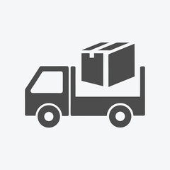 A flat gray delivery truck carries a big gray parcel on its back