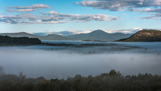 Mist and fog settling in valleys in the morning in Maine woods