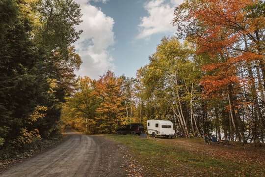 Camper at a campsite in the Maine woods with fall foliage