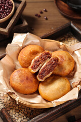 Handmade Red Bean Paste Filled Fried Donuts in Bamboo Basket - Traditional Asian Sweet Cake Dessert