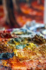 A painter at work in a cozy studio full of paintings. Capturing the artistic process and atmosphere.