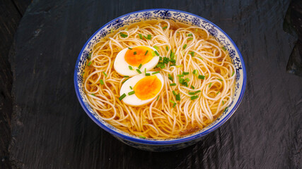 Homemade Ramen Noodle Soup with Soft-Boiled Eggs in Traditional Asian Bowl