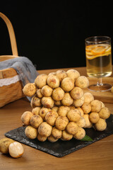 Fresh Small Potatoes on Slate Board with Glass and Wicker Basket Kitchen Still Life