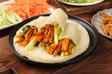 Handmade Spring Rolls with Beef and Fresh Vegetables on Wooden Table