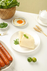 Handmade pork sausages with spring vegetables and cake rolls breakfast meal