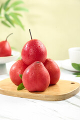 Fresh Red Pears from New Zealand on Wooden Cutting Board with Water Droplets