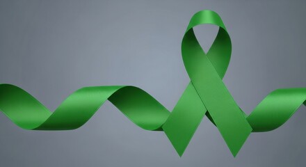 A long, flowing green awareness ribbon for mental health, liver, or environmental causes, waving on a simple grey background.