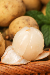 Fresh Longan Tropical Fruit from Thailand Peeled and Sliced on Bamboo Mat