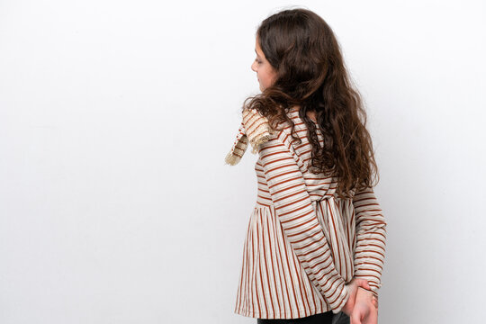 Little girl isolated on white background in back position and looking back