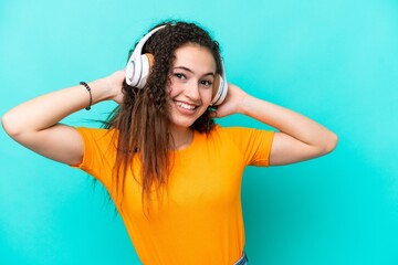 Young Arab woman isolated on blue background listening music